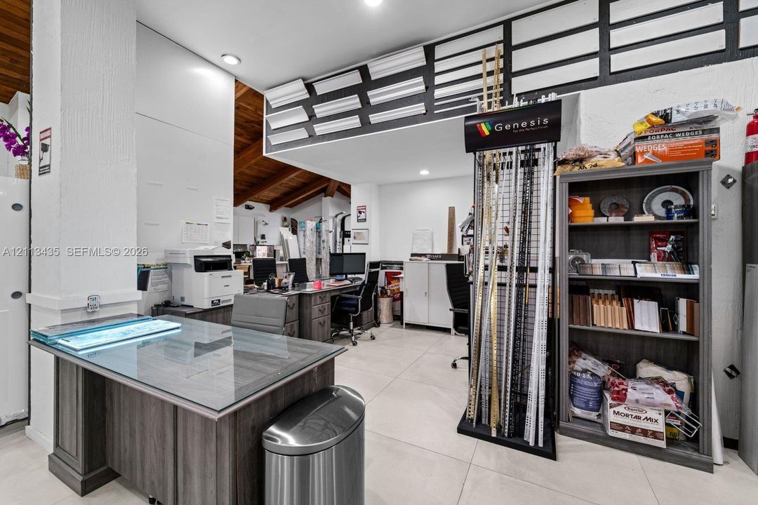 Interior space featuring vaulted wood-plank ceiling, large-format tile flooring, recessed lighting, and wall-mounted crown molding displays