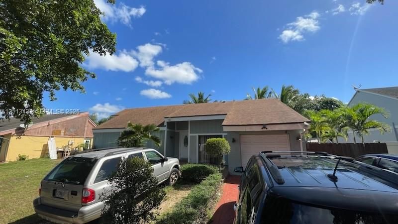 Single-story residence featuring a shingle roof, lap siding exterior, attached one-car garage, and a brick-paved walkway