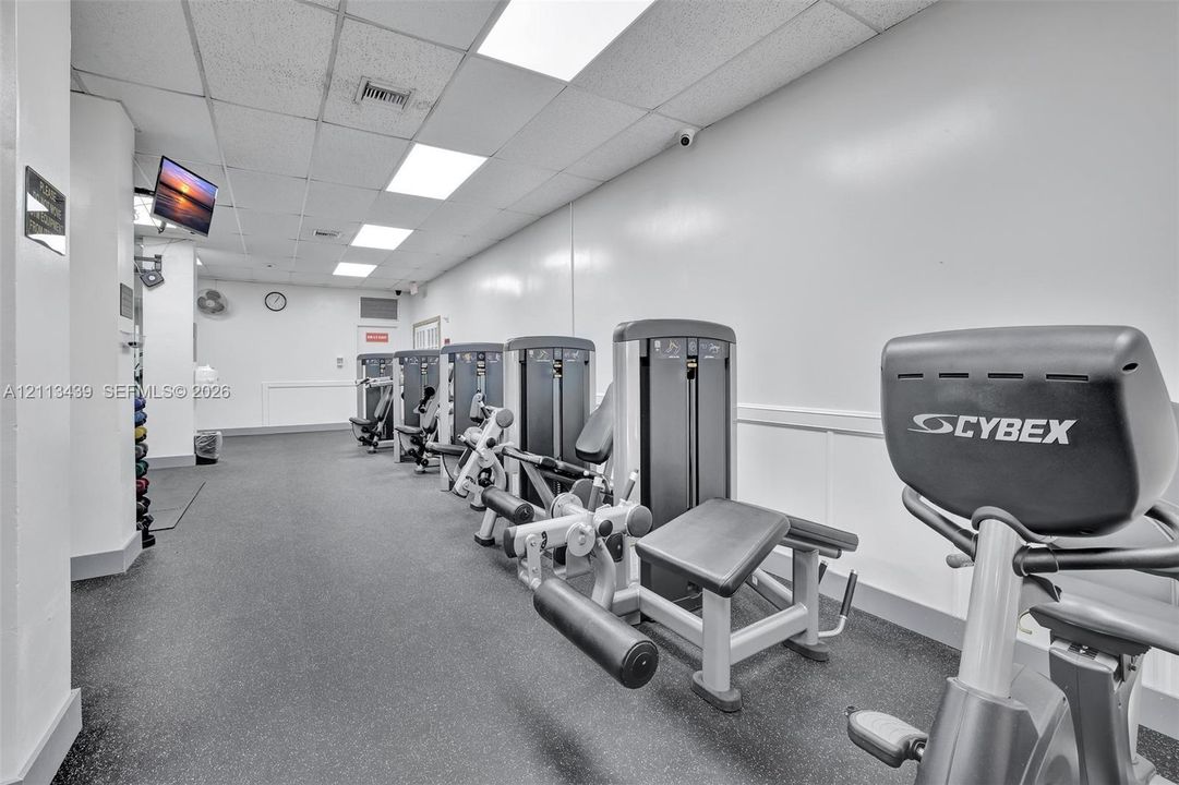 Fitness center featuring durable rubberized flooring, recessed ceiling lighting, and built-in weight training equipment