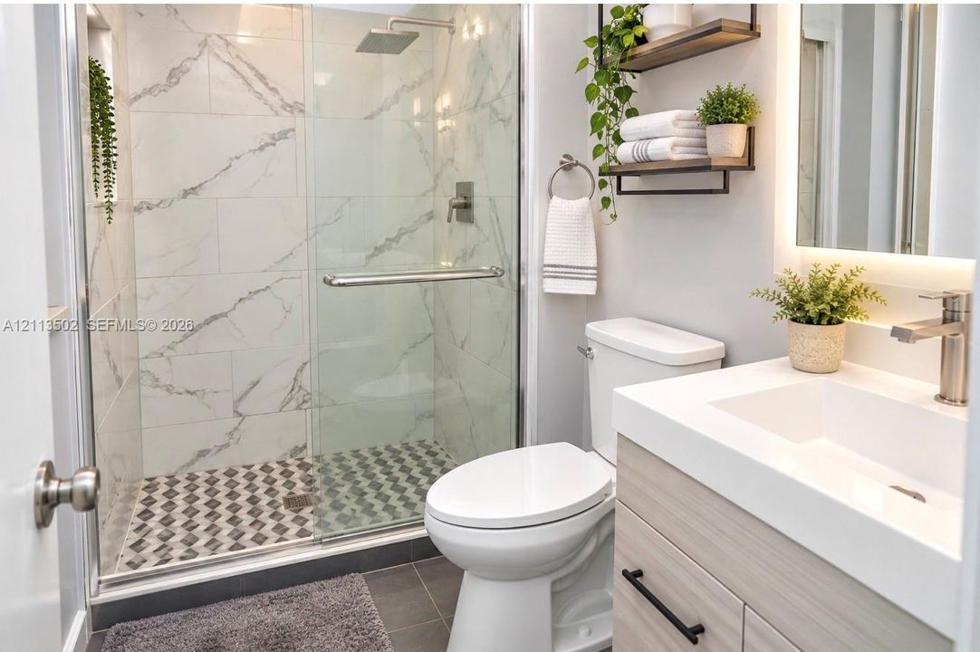 Walk-in shower with stone-finish tile surround and rain-style showerhead, glass enclosure, vanity with integrated basin and matte black hardware, and wall-mounted shelving