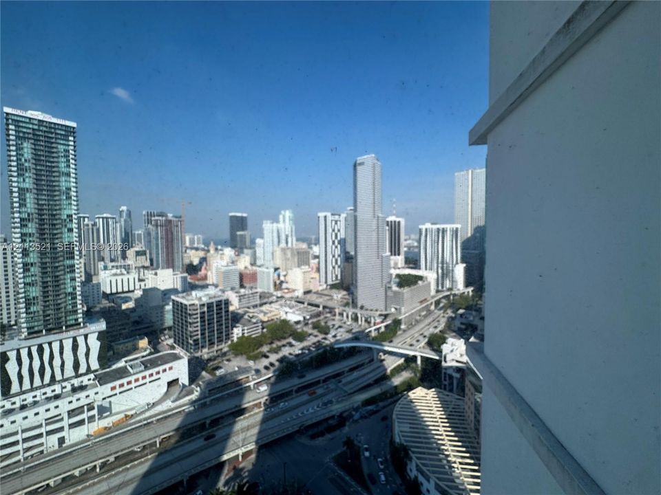 High-rise perspective featuring an expansive cityscape backdrop with urban infrastructure and surrounding skyscrapers