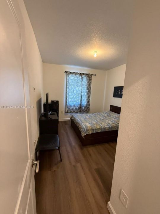 Room featuring wood-finish flooring and a single window