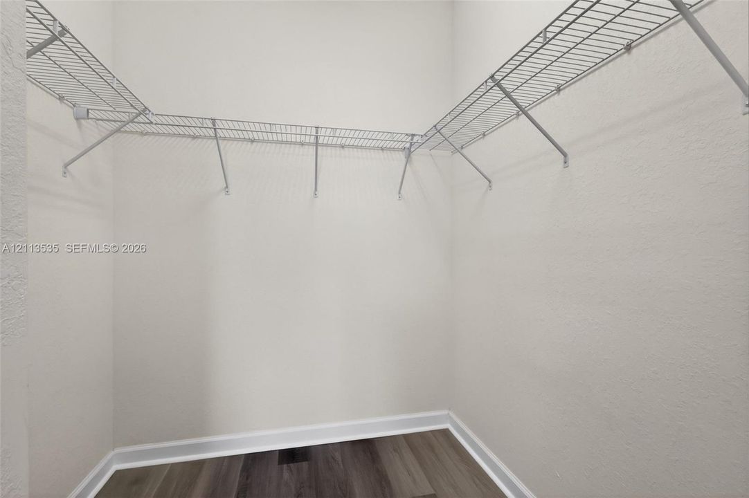 Storage space featuring wood-finish flooring and white wire shelving