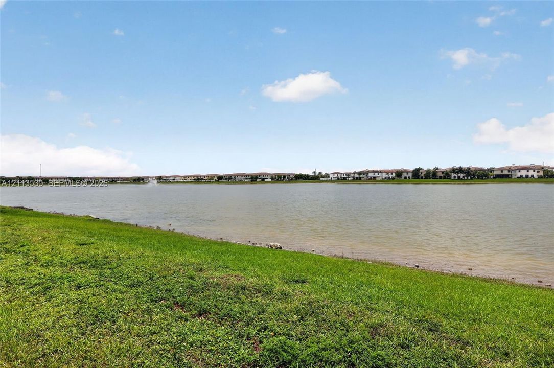 Expansive waterfront lot featuring a wide natural shoreline and manicured grass grounds