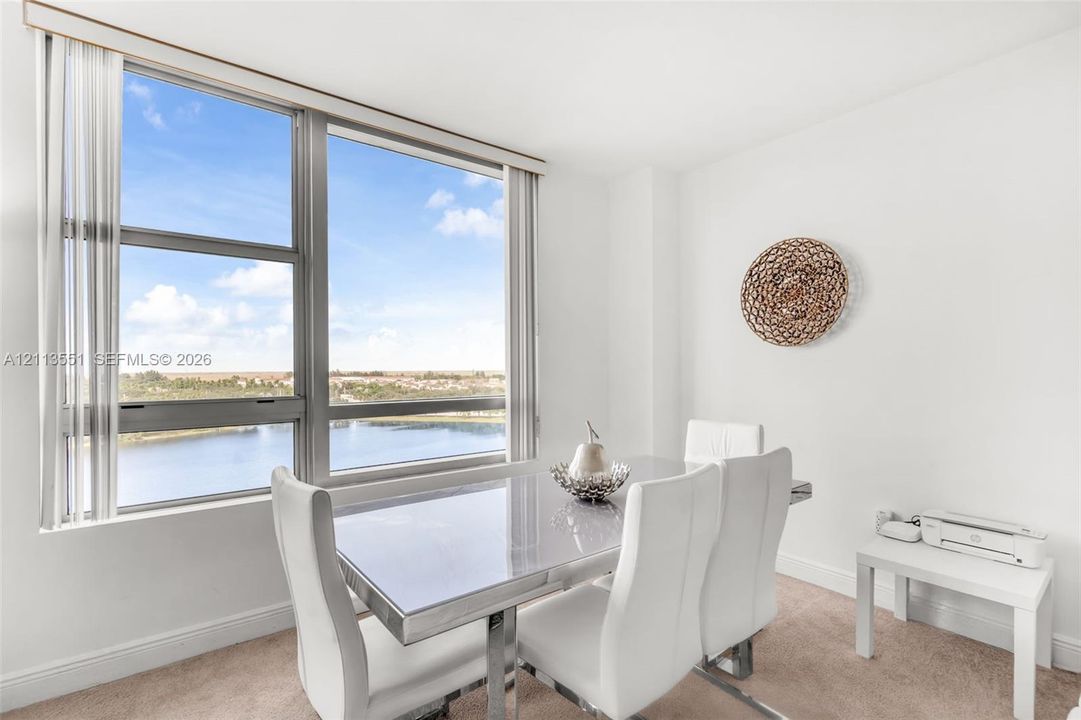 Expansive floor-to-ceiling windows featuring aluminum framing and neutral wall finishes