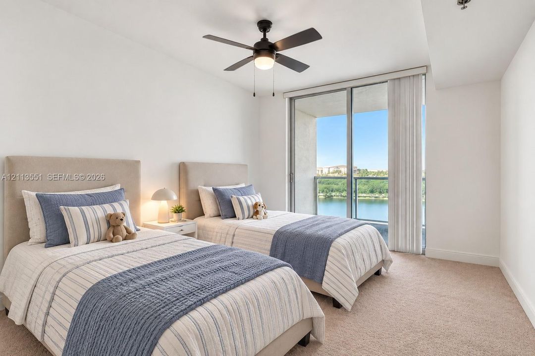 Wall-to-wall carpeting, ceiling fan with integrated lighting, and floor-to-ceiling glass sliding doors leading to a private balcony