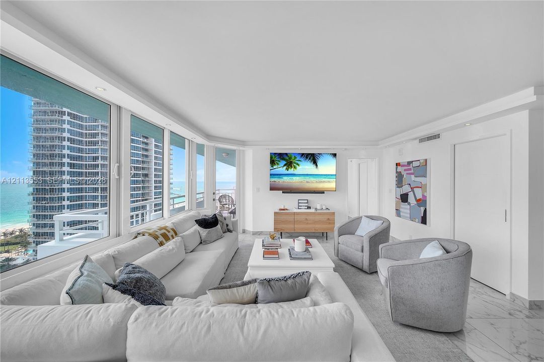 Floor-to-ceiling windows, stone-finish flooring, recessed ceiling lighting, and built-in door hardware