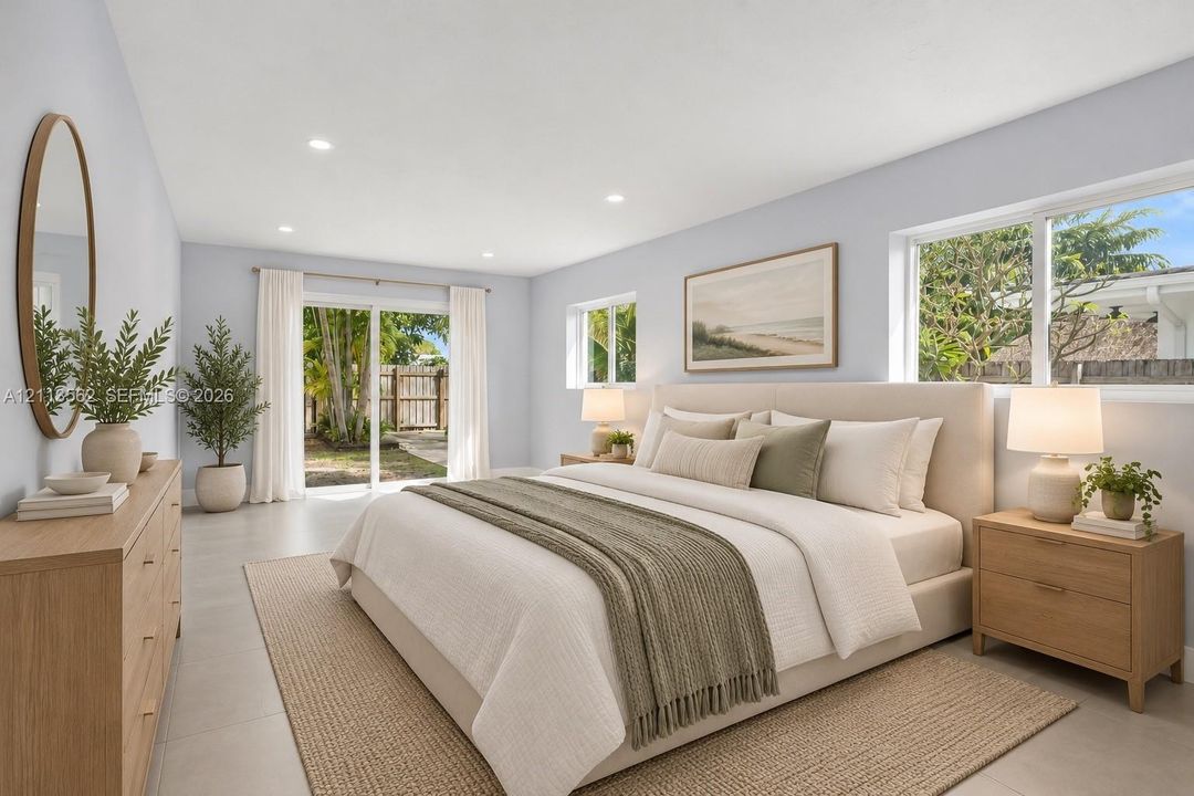 Neutral-toned interior featuring large-format tile flooring, recessed lighting, and sliding glass doors