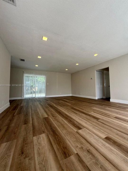 Interior space featuring wood-finish flooring, recessed lighting, and a glass sliding door