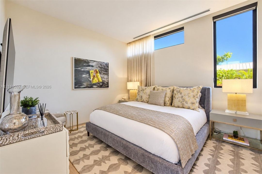Neutral interior featuring a tall, vertical window, a horizontal clerestory window, and clean-lined wall surfaces