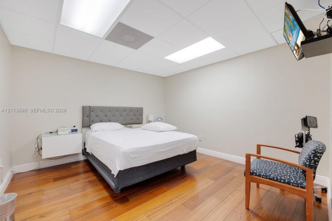 Wood-finish flooring, recessed ceiling lighting, and neutral wall tones