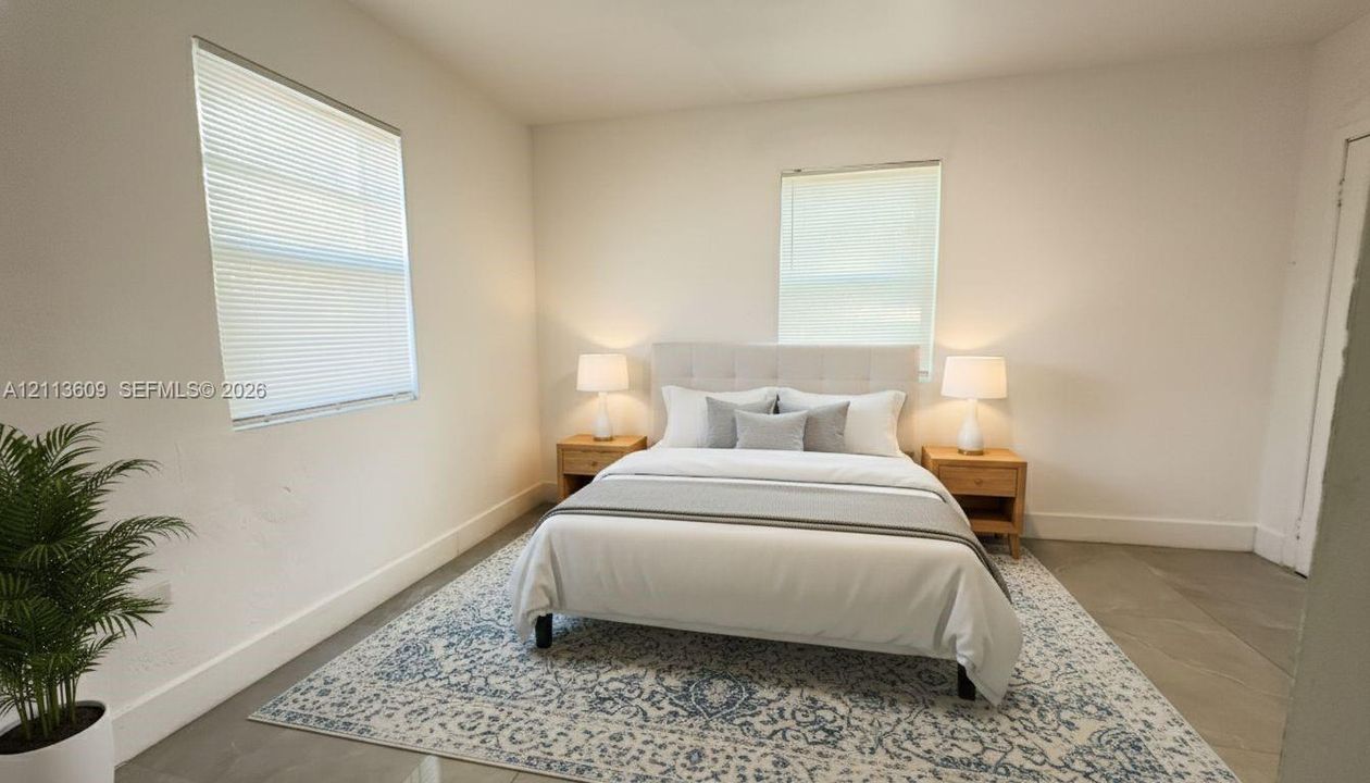 Neutral interior space featuring polished concrete flooring, two windows with horizontal blinds, and smooth-finish walls