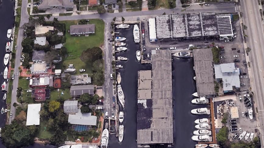 Aerial perspective featuring multiple boat slips, deep-water canal access, and covered storage facilities