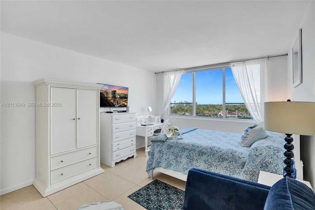 Expansive window featuring floor-to-ceiling glass panes and large-format tile flooring