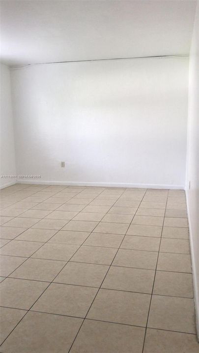 Interior space featuring light-toned ceramic tile flooring and neutral painted walls