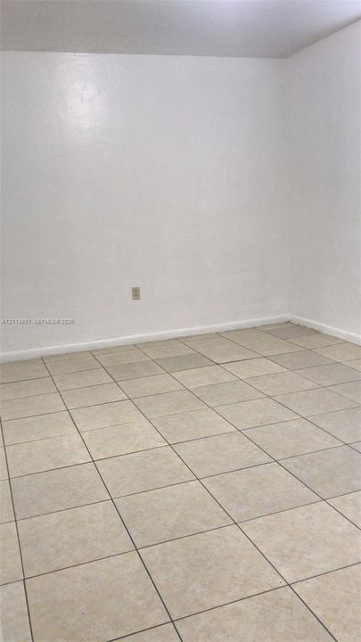 Room featuring light-toned tile flooring and neutral wall finishes