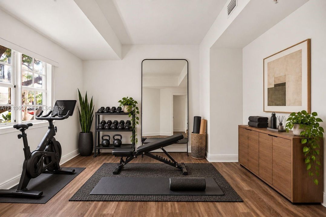 Multipurpose room featuring wood-finish flooring, multi-pane windows, and a built-in recessed ceiling light fixture