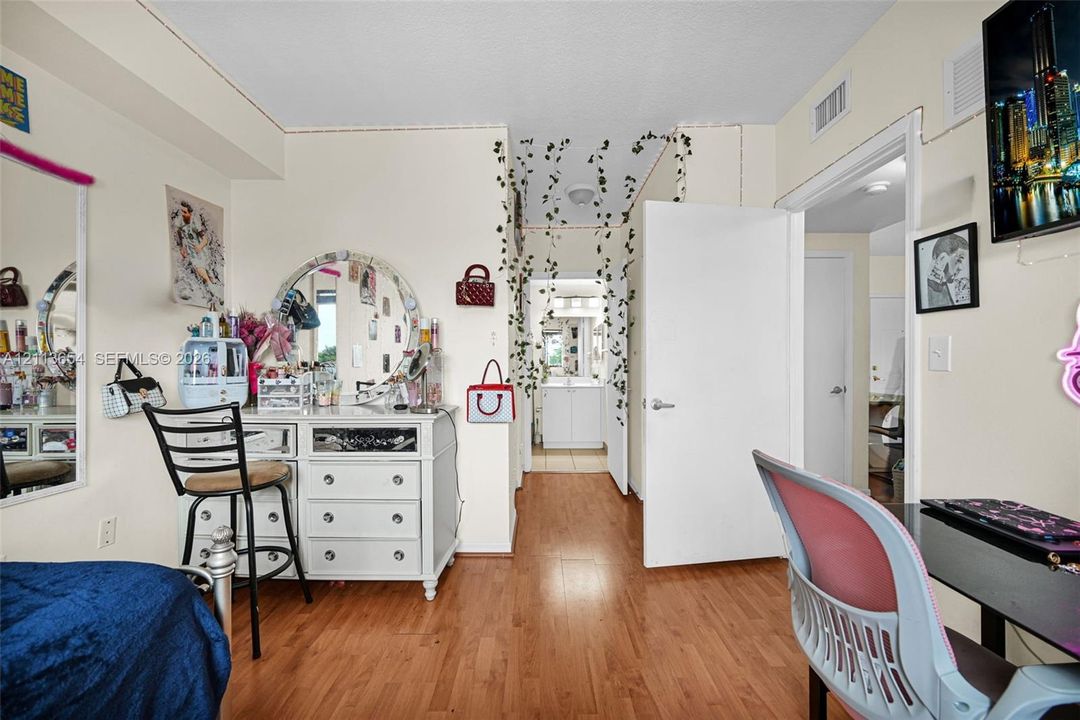 Interior room featuring wood-finish flooring and neutral wall color