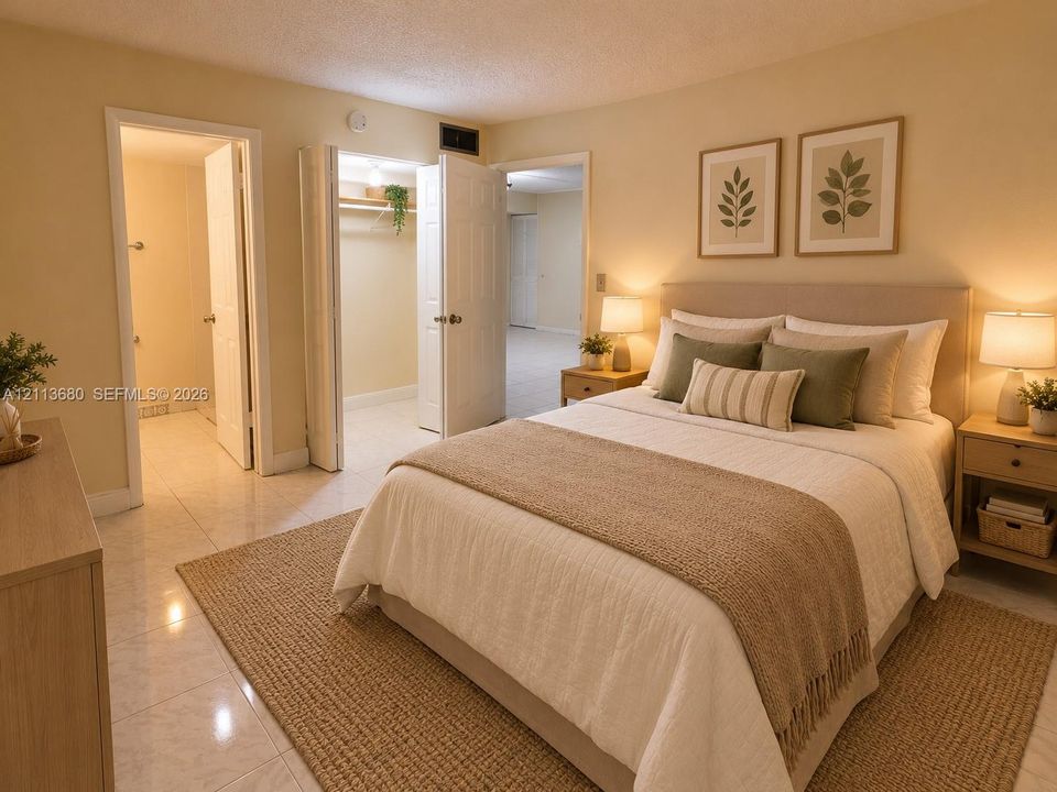 Neutral-tone interior featuring light-reflecting tile flooring, panel-style doors, and a built-in closet with integrated shelving