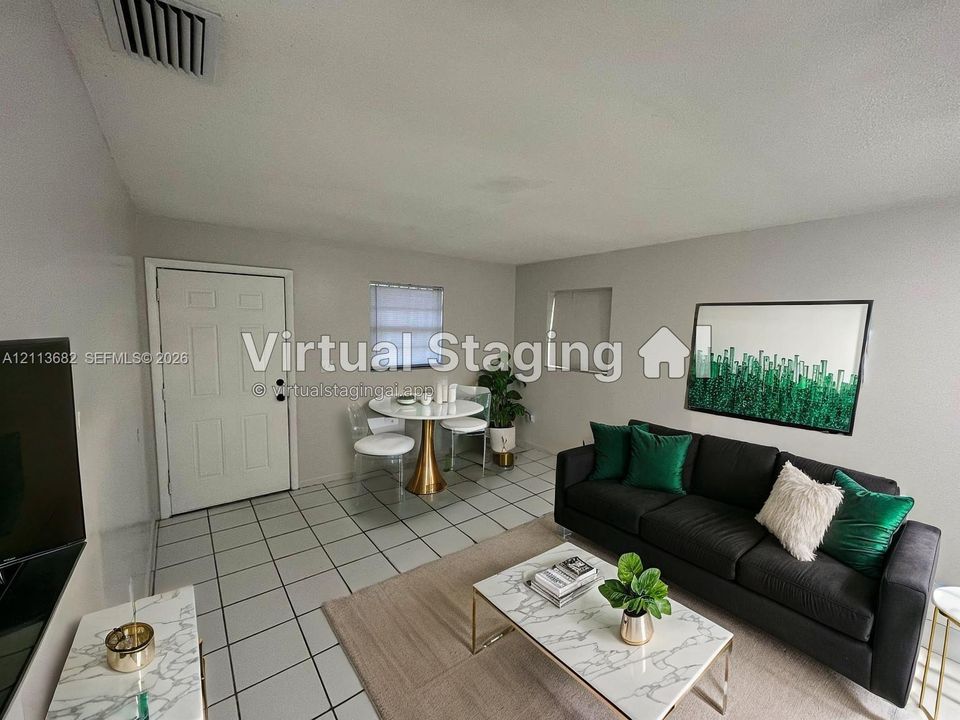 Open-concept interior featuring light-colored wall paint and neutral ceramic tile flooring throughout
