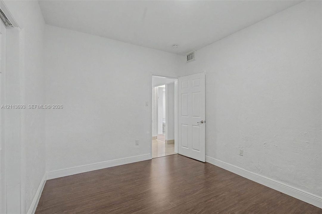 Interior room featuring neutral wall finishes and wood-finish flooring