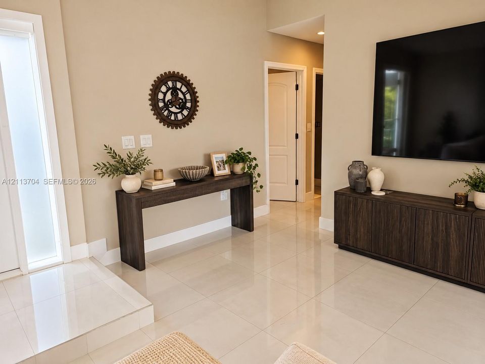 Polished light-toned tile flooring, door with frosted glass panel, and neutral wall color