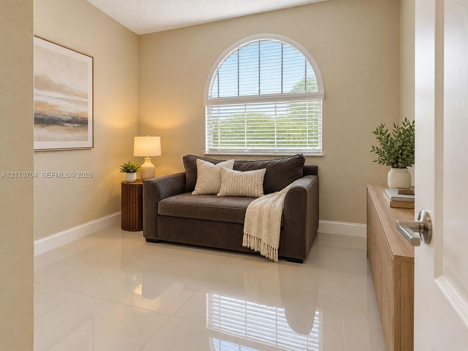 Polished tile flooring and arched window featuring horizontal blinds