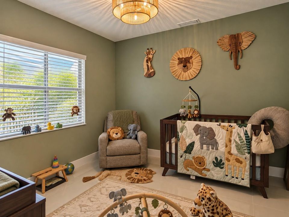 Neutral-toned room featuring a tiered drum-style ceiling light fixture, oversized window with horizontal blinds, and tile flooring