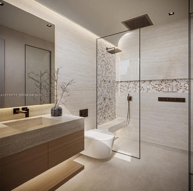 Floating wood-finish vanity with stone-top sink, walk-in glass-enclosed shower featuring a built-in stone bench, integrated wall-mounted rain showerhead, and recessed LED accent lighting