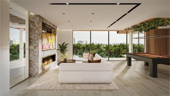 Open-concept interior featuring large-format stone flooring, floor-to-ceiling glass walls, a floor-to-ceiling natural stone fireplace surround, and integrated recessed linear lighting
