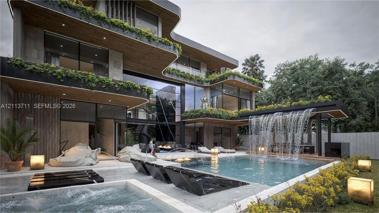 Contemporary multi-level exterior featuring floor-to-ceiling glass walls, integrated balcony greenery, a cascading water feature, a swimming pool with tiered hardscaping, and a built-in spa