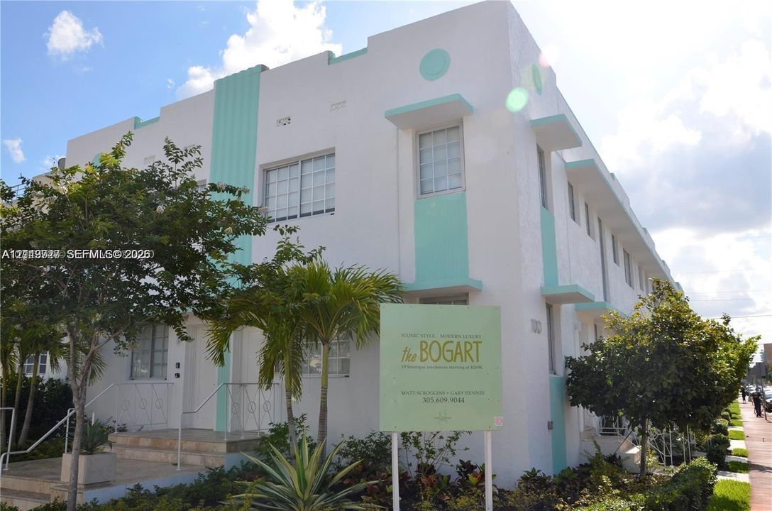 Art Deco exterior featuring geometric detailing, clean stucco facade, and metal railings