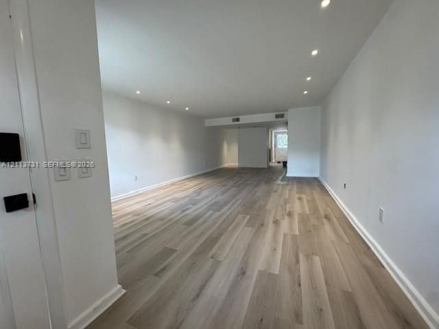Open-concept interior featuring wood-finish flooring and recessed lighting