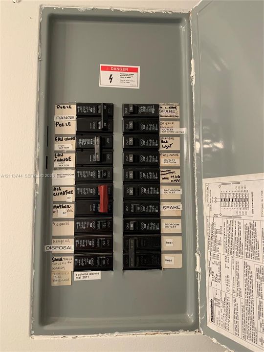 Electrical service panel with a centralized circuit breaker configuration and detailed circuit labeling