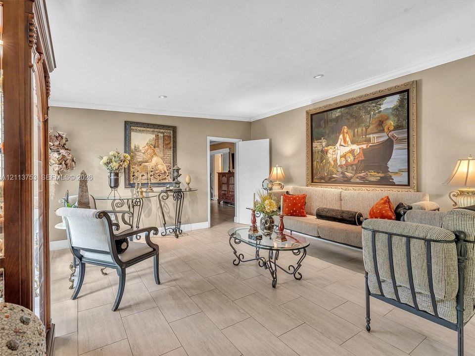 Spacious interior featuring neutral wall tones, large-format tile flooring, and recessed ceiling lighting