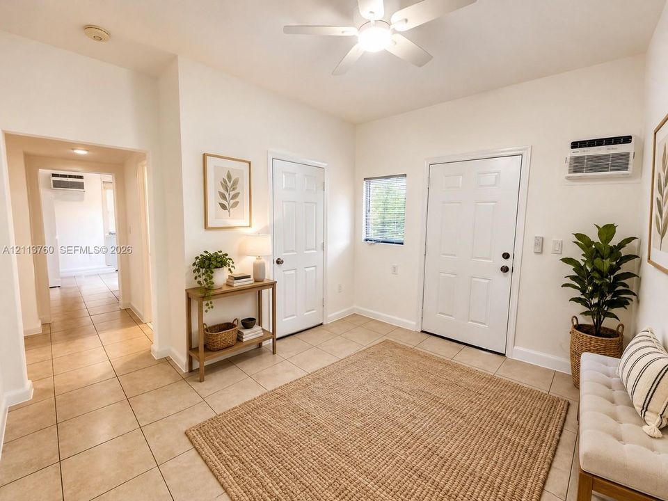 Neutral-toned ceramic tile flooring, six-panel interior doors, recessed ceiling lighting, and a white ceiling fan with integrated light fixture