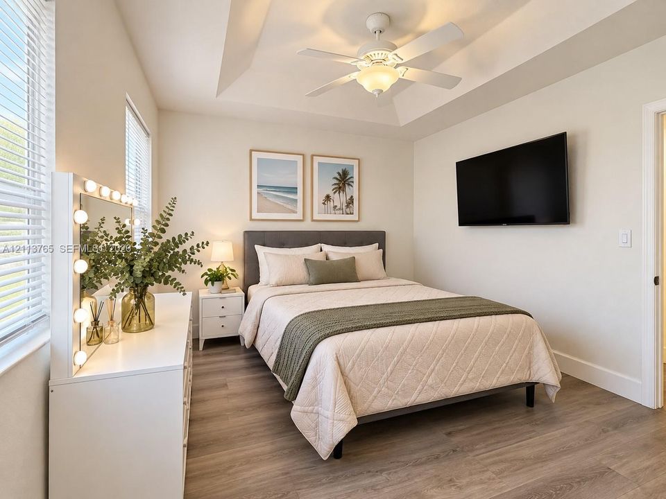 Tray ceiling, wood-finish flooring, and white horizontal blinds