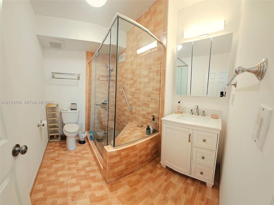 Living area featuring ceramic tile flooring, floor-to-ceiling windows, a glass-panel exterior door, and a ceiling-mounted fan