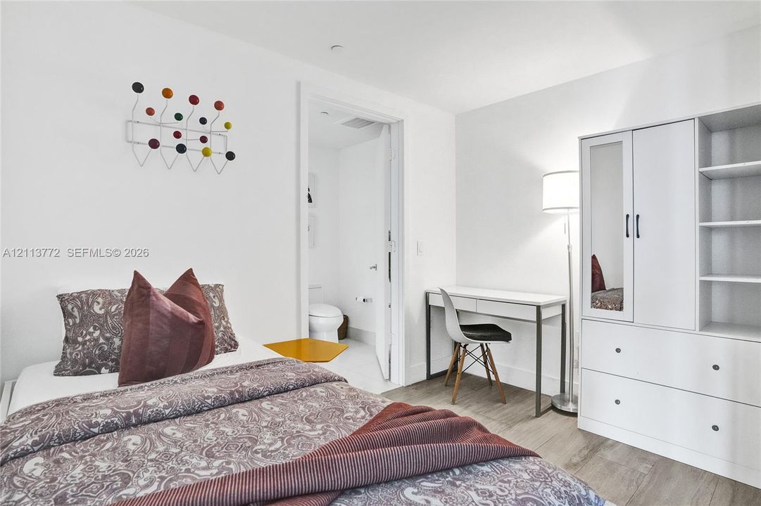 Room with wood-finish flooring and neutral wall tones