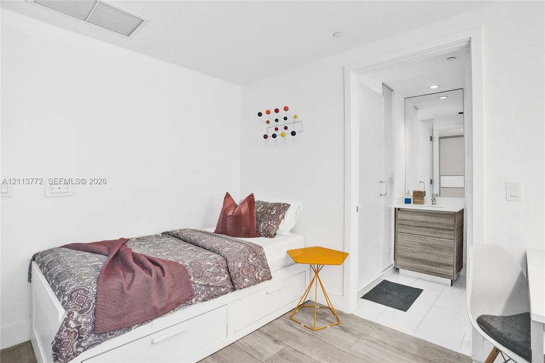 Wood-finish flooring, built-in storage cabinetry, and recessed lighting