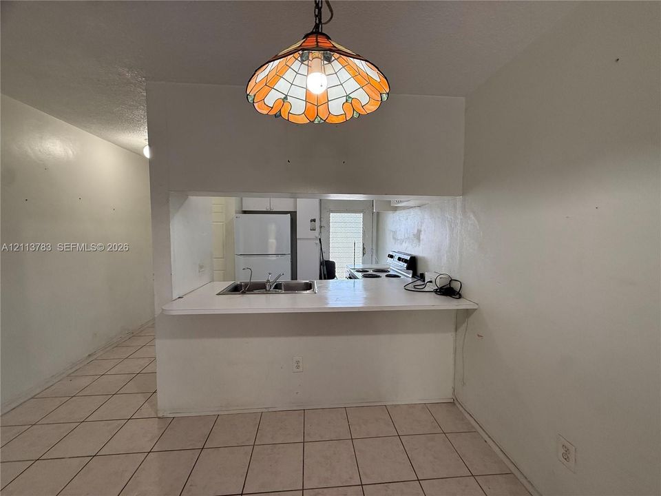 Ceramic tile flooring, sliding glass door, and wooden horizontal blinds