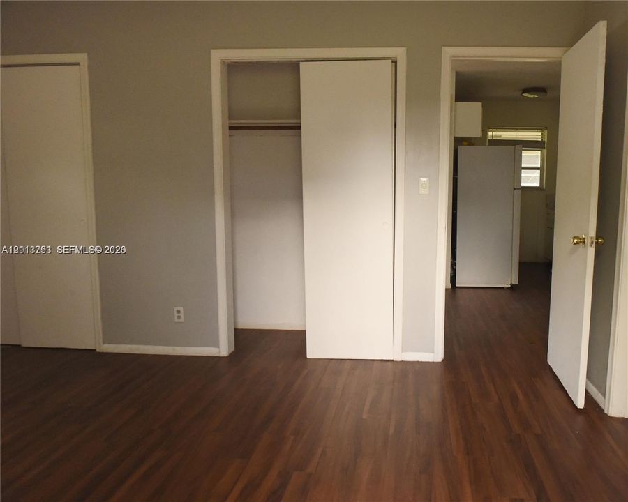 Wood-finish flooring, two sets of closet doors, and interior hinged passage door