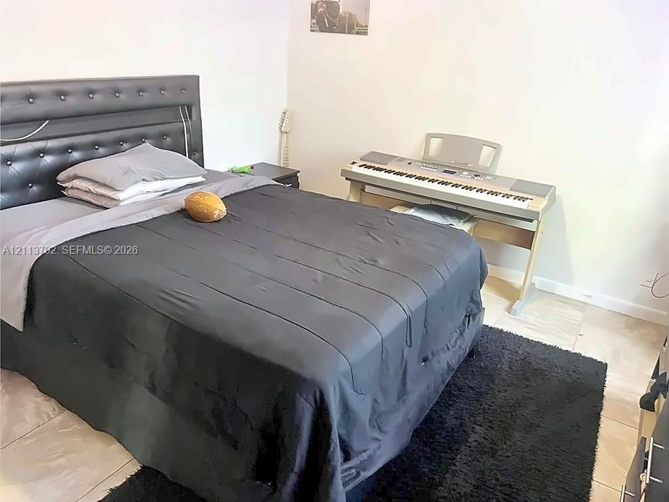 Room featuring neutral wall finishes and large-format tile flooring