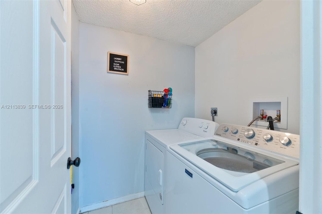 Laundry area featuring washer and dryer hookups with dedicated water supply lines and recessed wall box