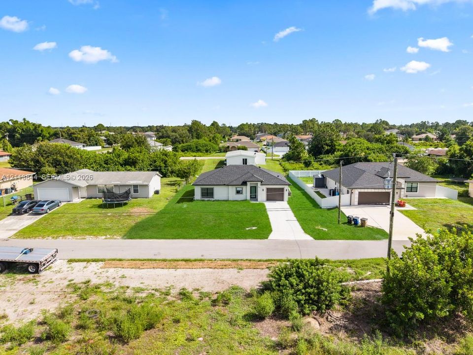 Single-story residence featuring a hipped roof, attached one-car garage, concrete driveway, and a manicured lawn