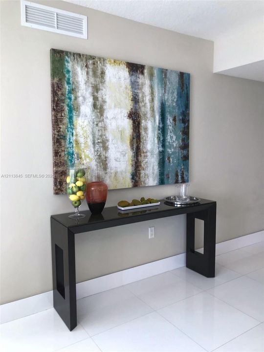 Glossy white tiled flooring and neutral wall paint
