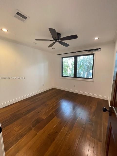 Room featuring wood-finish flooring, recessed lighting, ceiling fan, and dark-framed window