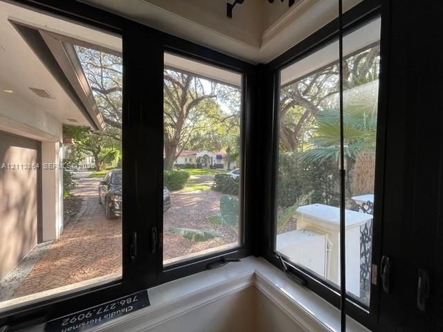Multi-pane corner windows with black frames and exterior scenery