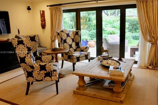 Black-framed multi-panel glass doors with patio access