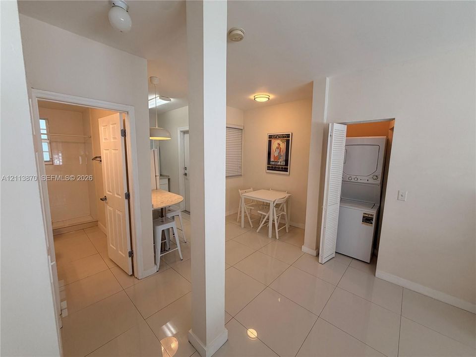 Interior space featuring large-format tile flooring, recessed lighting, and a dedicated laundry closet with louvered doors